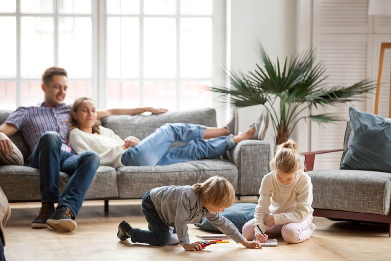 Familie genießt die Wärme der Infrarotheizung im Wohnzimmer